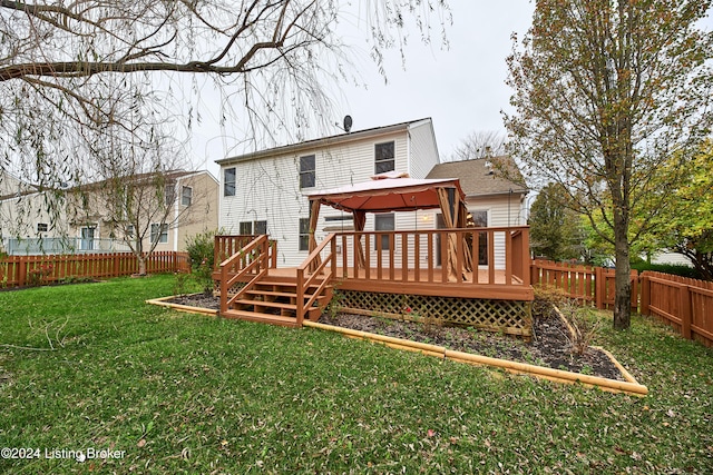 back of property with a gazebo, a yard, and a deck