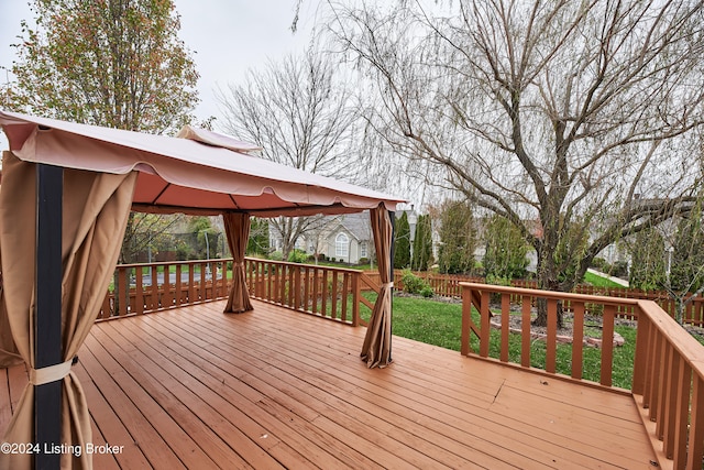 wooden deck featuring a gazebo and a yard