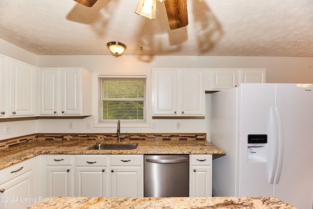 kitchen featuring white cabinetry, sink, white refrigerator with ice dispenser, and stainless steel dishwasher