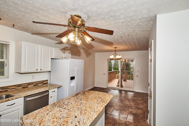 kitchen with hanging light fixtures, dishwasher, white refrigerator with ice dispenser, and white cabinets