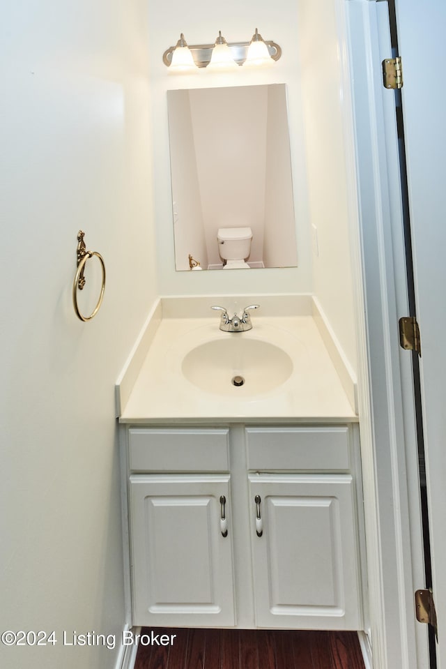 bathroom featuring vanity and toilet