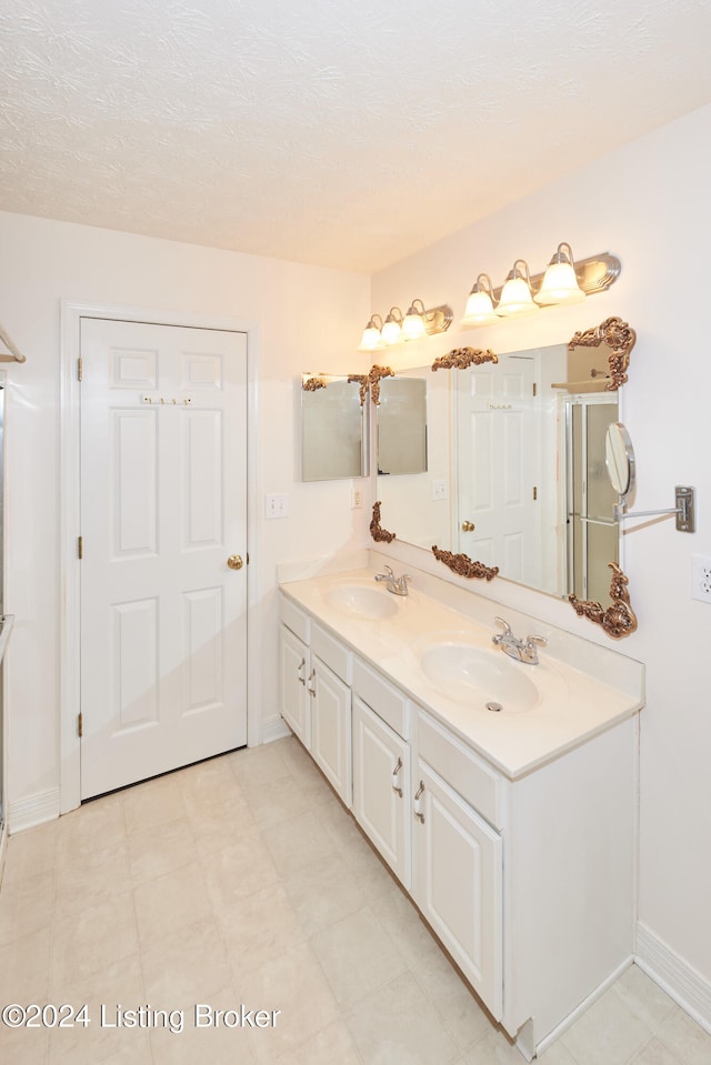 bathroom with vanity and a textured ceiling