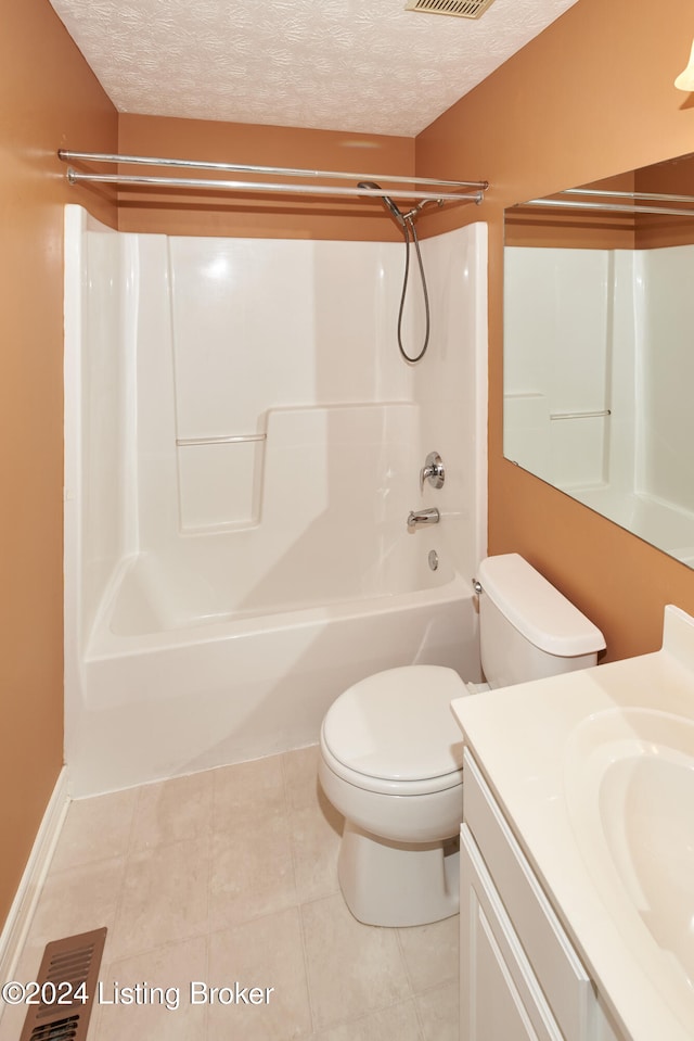 full bathroom featuring toilet, bathing tub / shower combination, a textured ceiling, vanity, and tile patterned flooring