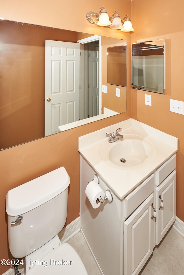 bathroom featuring vanity, tile patterned floors, and toilet