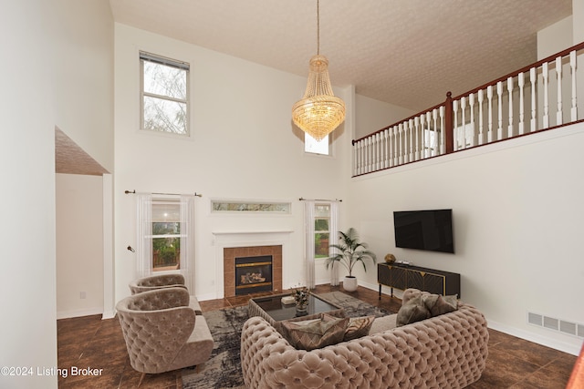 living room with a towering ceiling and a fireplace