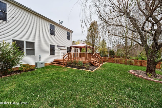 view of yard with central AC unit, a gazebo, and a deck