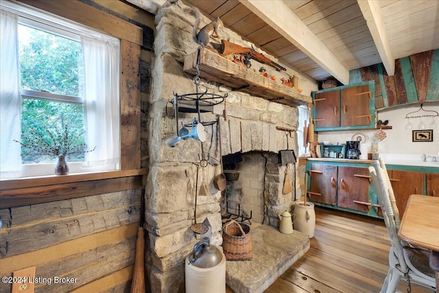 interior space with beam ceiling and light hardwood / wood-style flooring