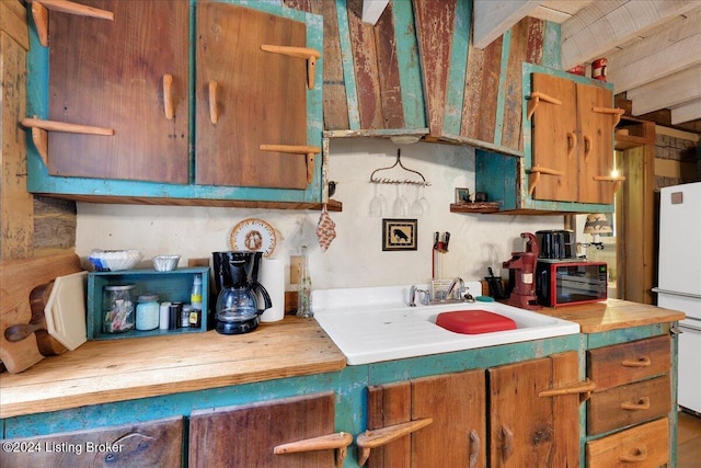 kitchen with sink and white refrigerator