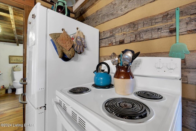 kitchen featuring white cabinets, white electric range oven, and wood-type flooring