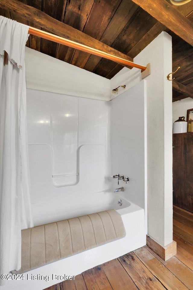 bathroom with lofted ceiling with beams, wood-type flooring, wood ceiling, and shower / tub combo with curtain