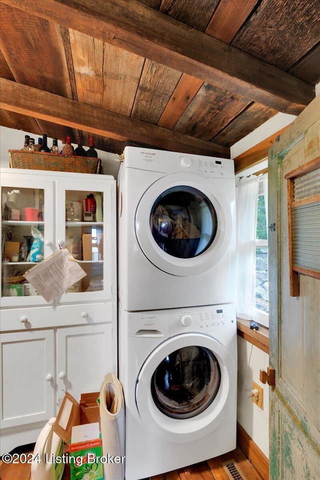 clothes washing area with wooden ceiling, stacked washing maching and dryer, and light hardwood / wood-style floors