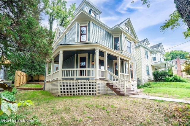 view of front of home featuring covered porch and a front yard