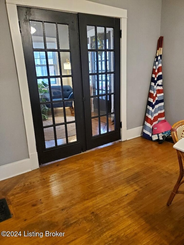 doorway to outside with wood-type flooring and french doors