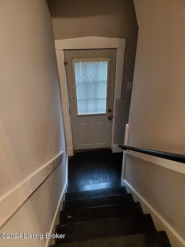 stairway featuring wood-type flooring