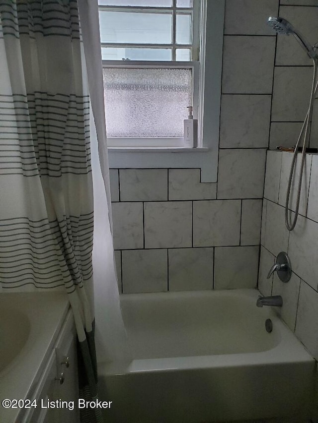 bathroom featuring vanity and shower / bath combo