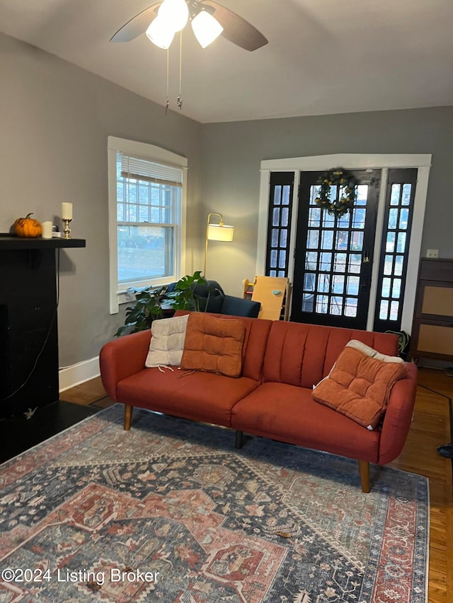 living room with hardwood / wood-style floors and ceiling fan