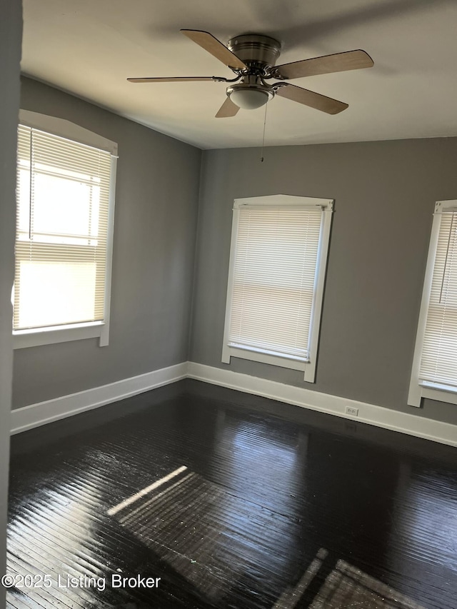 empty room with hardwood / wood-style floors and ceiling fan