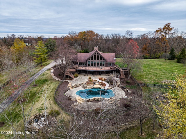 exterior space with a patio, a wooden deck, a yard, and a water slide