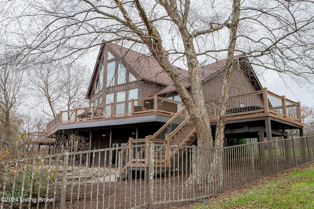 rear view of property featuring a wooden deck