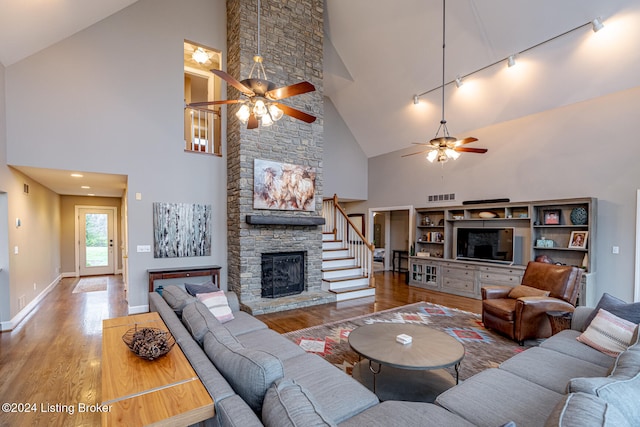 living room with ceiling fan, hardwood / wood-style flooring, rail lighting, and high vaulted ceiling