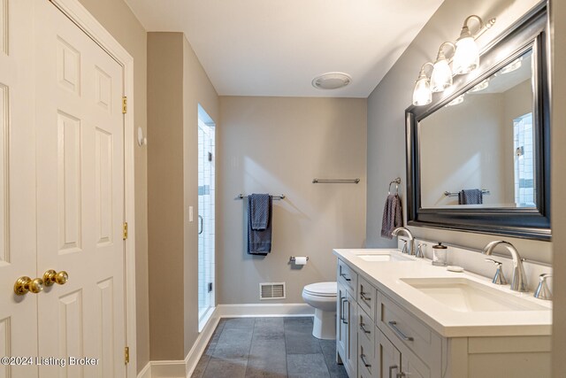 bathroom featuring plenty of natural light, vanity, an enclosed shower, and toilet