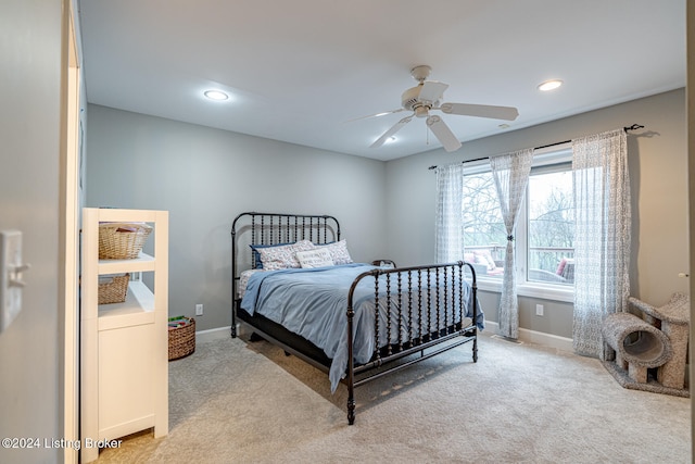 bedroom featuring ceiling fan and light carpet