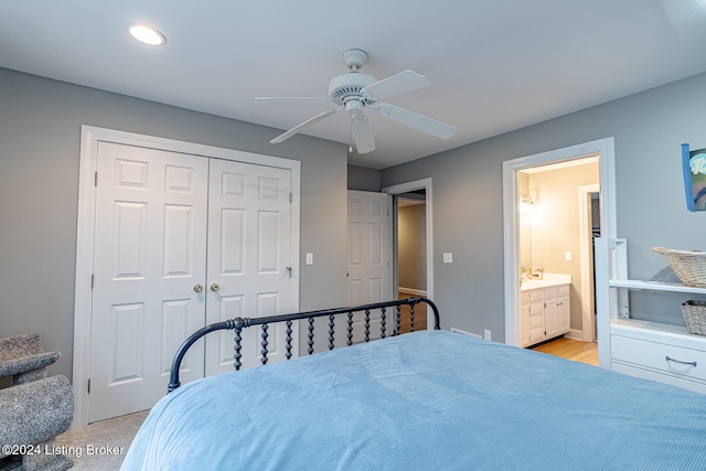 carpeted bedroom with ceiling fan, a closet, and ensuite bathroom