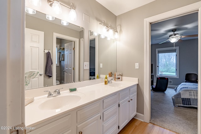 bathroom with vanity, hardwood / wood-style flooring, toilet, and ceiling fan