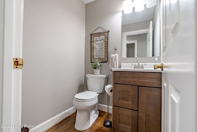 bathroom with vanity, hardwood / wood-style flooring, and toilet