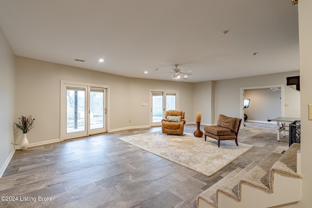 sitting room with ceiling fan, light wood-type flooring, a wealth of natural light, and french doors