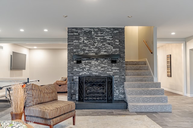 living room with a stone fireplace