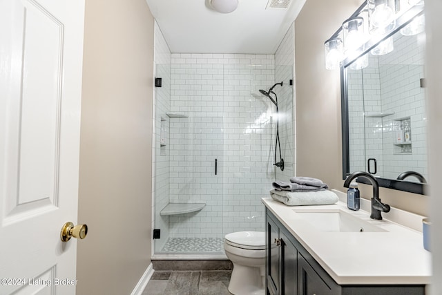 bathroom with vanity, toilet, and walk in shower