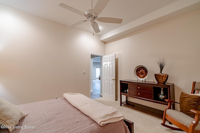 carpeted bedroom with ceiling fan and a towering ceiling