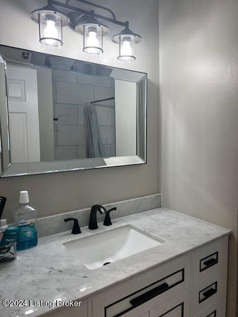 bathroom featuring vanity and curtained shower