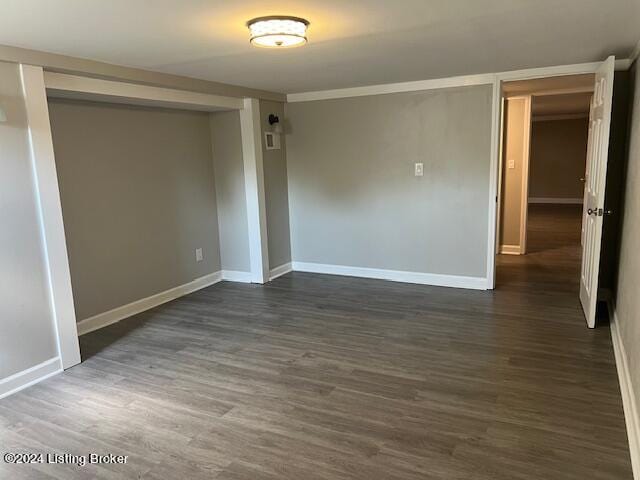 spare room with dark wood-type flooring