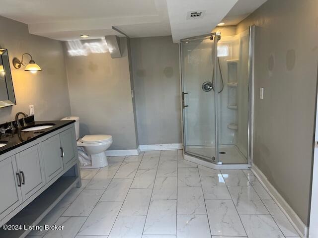 bathroom with vanity, toilet, and an enclosed shower