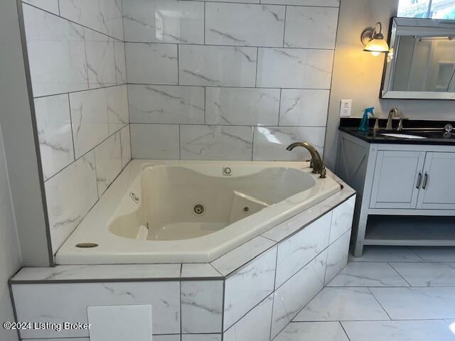 bathroom with tiled bath and vanity