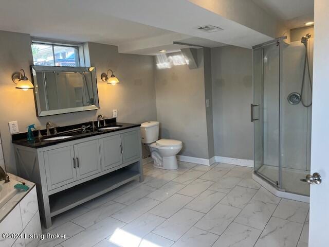 full bathroom featuring shower with separate bathtub, vanity, and toilet