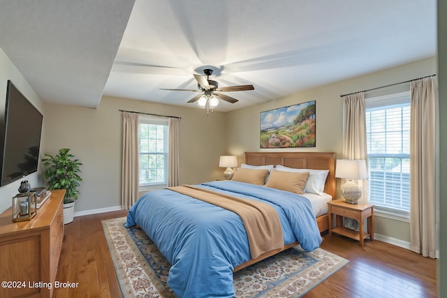 bedroom with ceiling fan and dark hardwood / wood-style flooring