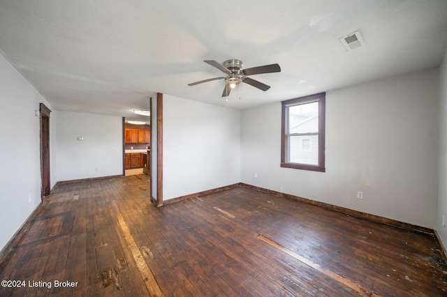 empty room featuring ceiling fan and dark wood-type flooring