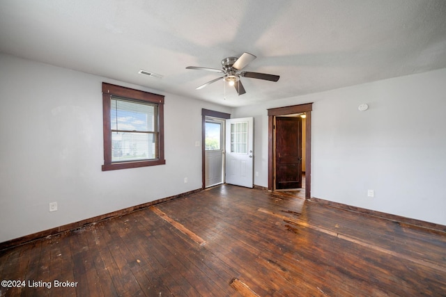 unfurnished room with dark hardwood / wood-style floors, ceiling fan, and a textured ceiling