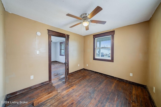 unfurnished room featuring dark hardwood / wood-style floors and ceiling fan