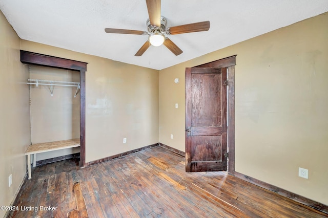 unfurnished bedroom with a closet, ceiling fan, and dark wood-type flooring