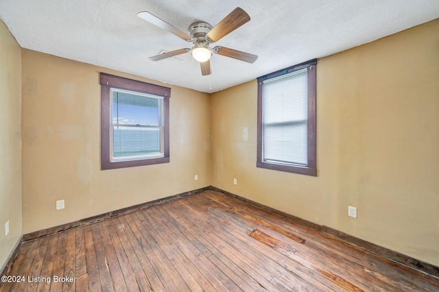 spare room with ceiling fan, hardwood / wood-style floors, and a textured ceiling