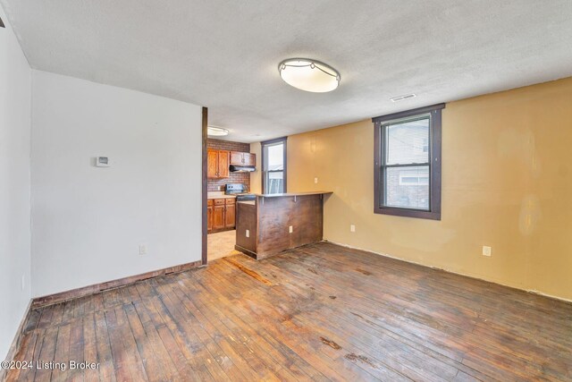 interior space featuring a textured ceiling and dark hardwood / wood-style floors