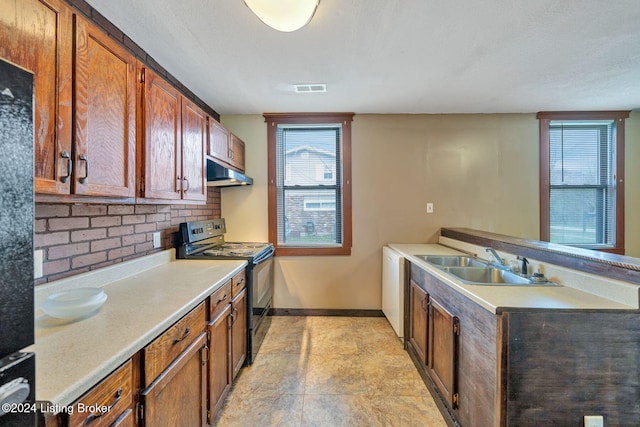 kitchen featuring tasteful backsplash, sink, and black range with electric cooktop