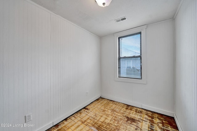 empty room featuring hardwood / wood-style floors and a textured ceiling