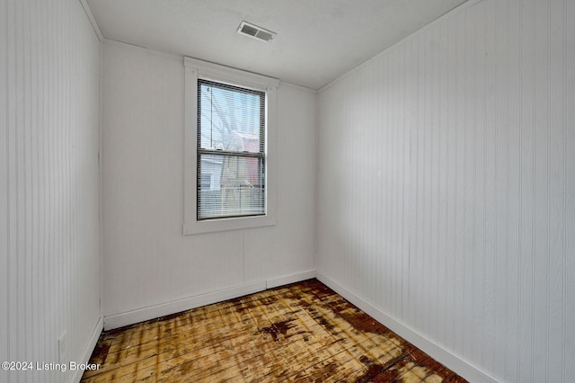 unfurnished room featuring wood-type flooring and a textured ceiling