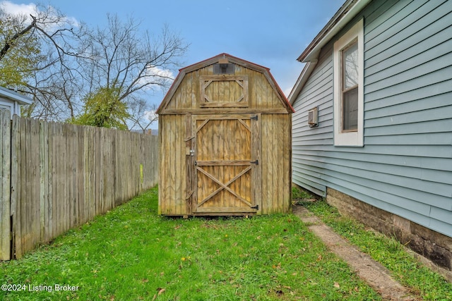 view of outbuilding featuring a lawn