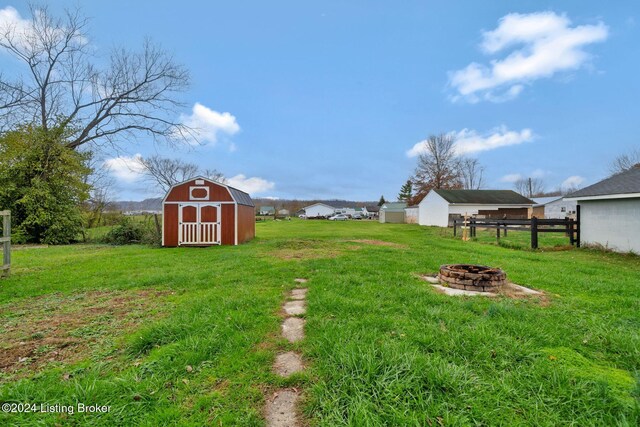 view of yard with a fire pit and a storage shed